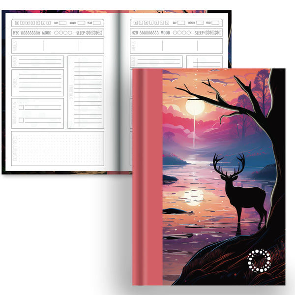 Deer in a Forest at Sunset on a notebook with a black and white planner interior
